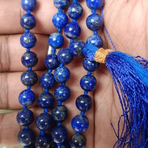 Lajwart Mala with natural lapis lazuli beads held in hand, showcasing deep blue spiritual prayer beads