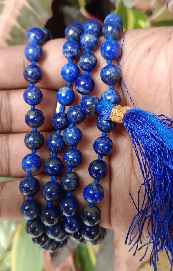 Lajwart Mala with natural lapis lazuli beads held in hand, showcasing deep blue spiritual prayer beads