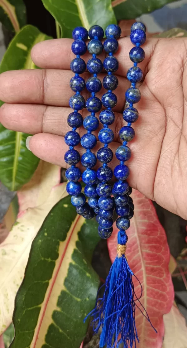 Lajwart Mala with natural lapis lazuli beads held in hand, showcasing deep blue spiritual prayer beads