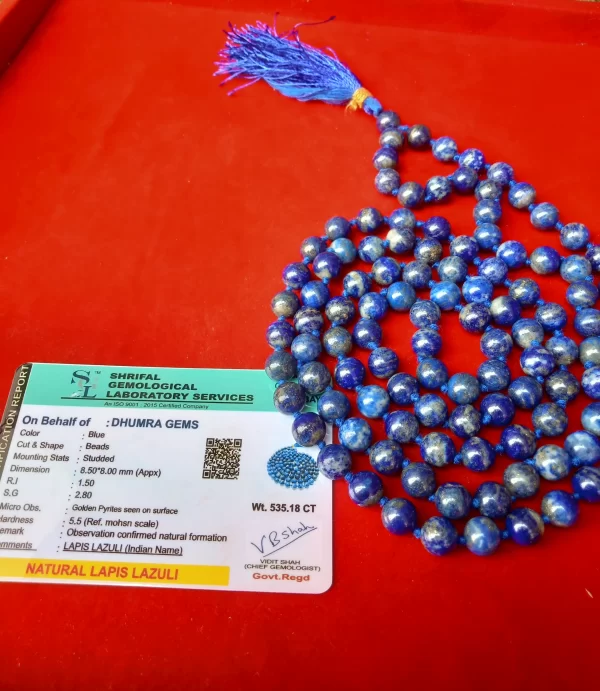Natural Lajwart Mala with gemstone certificate on red background, authentic lapis lazuli beads with tassel